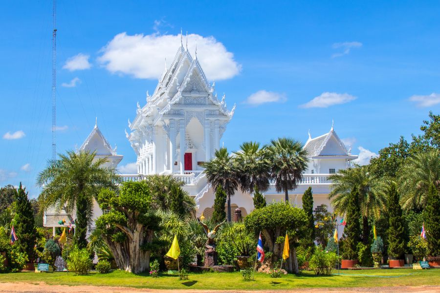 The distinctive white ordination hall of Wat Tham Khuha Sawan overlooking the Mekong