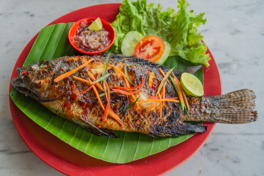 Freshly grilled river fish served with local dipping sauces and herbs