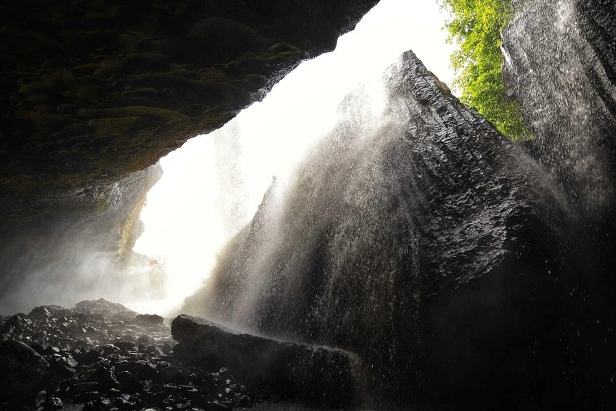 The cave is hidden behind layers of water