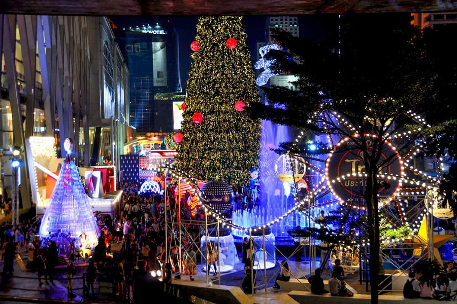 Tourist areas like Bangkok glow with lights and tall Christmas trees