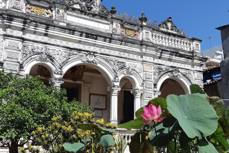The garden of Huynh Thuy Le Ancient House is a serene and beautifully landscaped outdoor space that complements the historical charm of the residence
