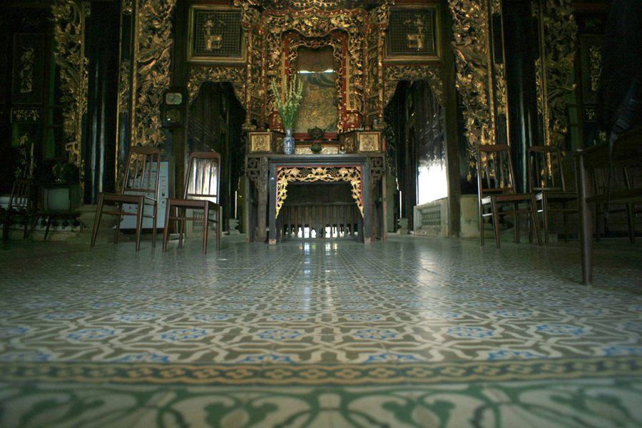 Inside the home, there are intricate decorations like dragons and bats on the center ceiling, as well as imported French stained glass and encaustic tiles