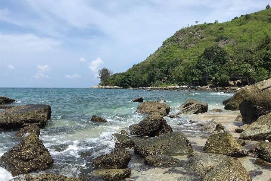 The rocky surroundings of Ao Sane Beach provide a distinctive and memorable coastal environment on the island of Phuket