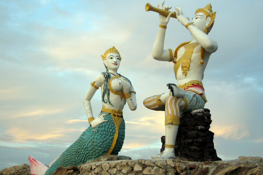 There is an interesting scene at Sai Kaew Beach of Koh Samet Island, the scene is set on a rock and consisted of statues of a mermaid and a man that seems to be peering through a telescope