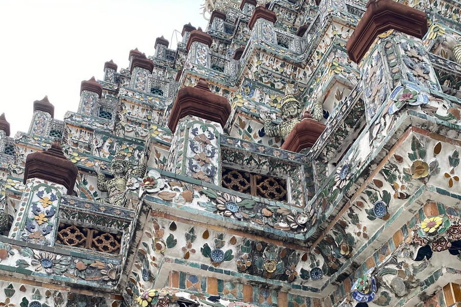 The decorative ceramic tiles at Wat Arun constitute a distinctive feature of the temple's architecture, contributing to its vibrant and visually captivating appearance