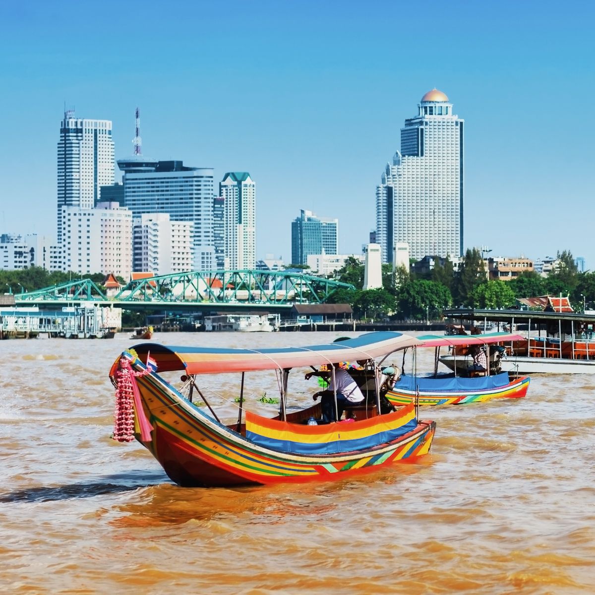 A couple of longtail boats carrying tourists on the Chao Phraya River