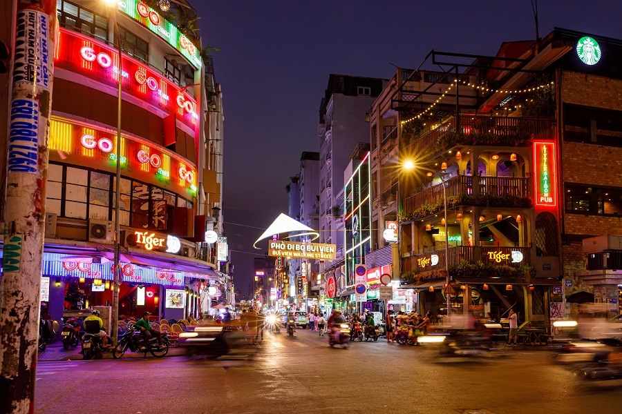 As darkness falls, Bui Vien Street bursts with energy