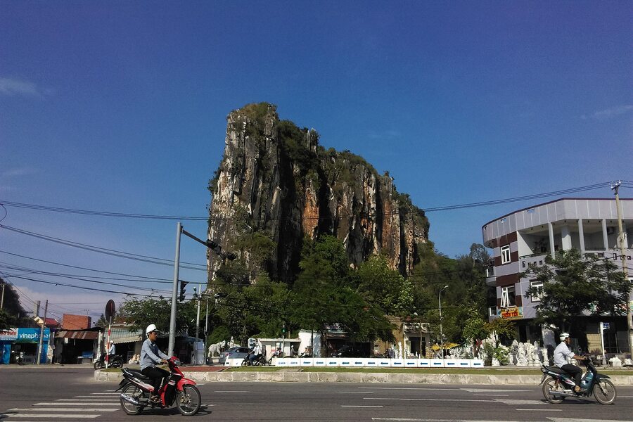 A majestic natural mountain between bustling cityscape
