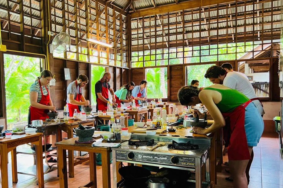 Visitors taking lesson in the cooking class