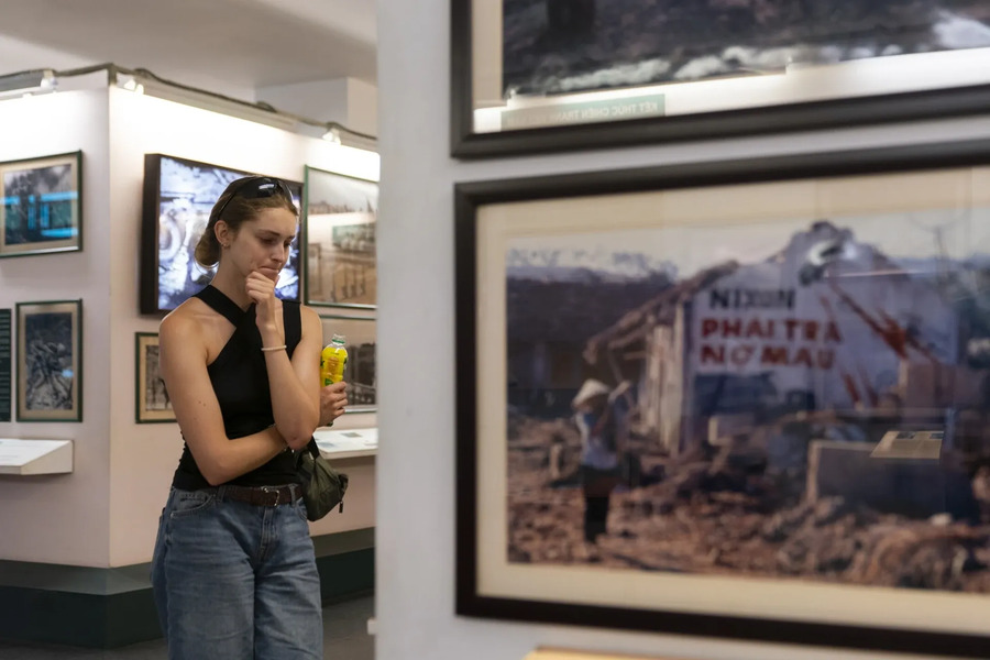 A female tourist was deeply moved by the images at the War Remnants Museum. Photo: ZNews