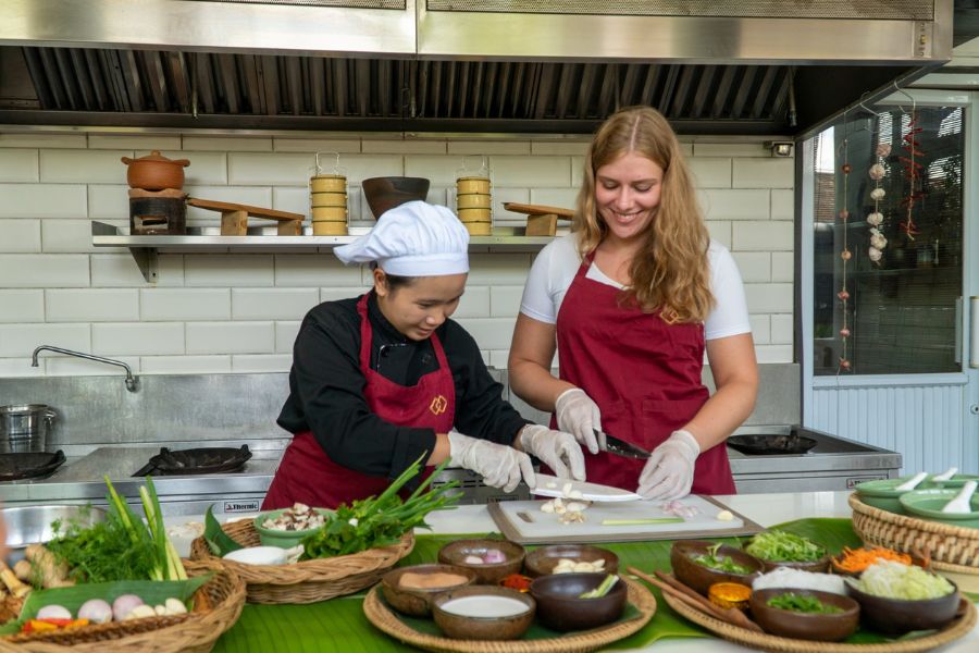 Tourists preparing Vietnamese meal from scratch