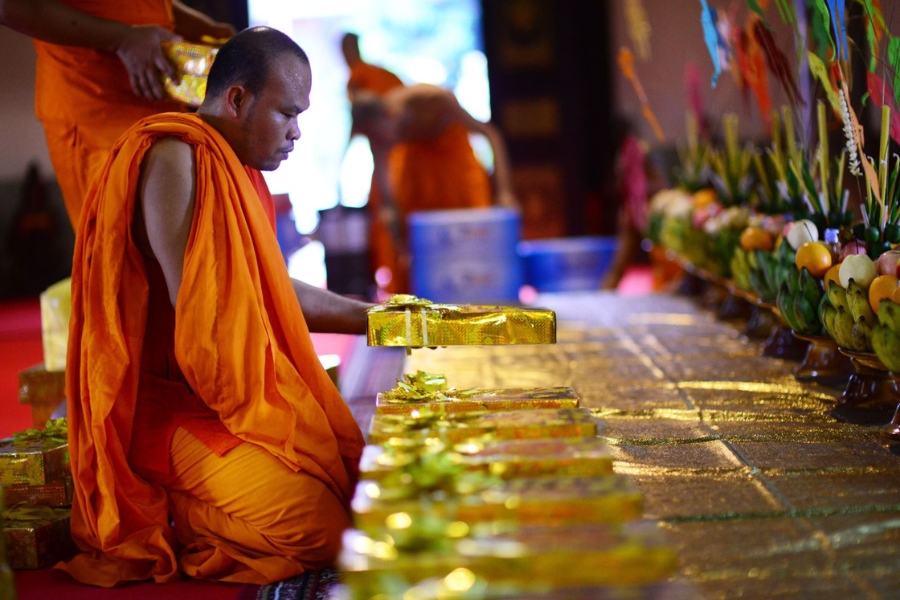 People offer essentials to the monks as a sign of respect