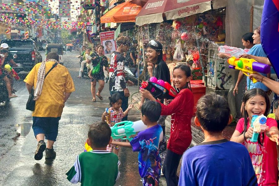 Kids playing with water guns for the festival