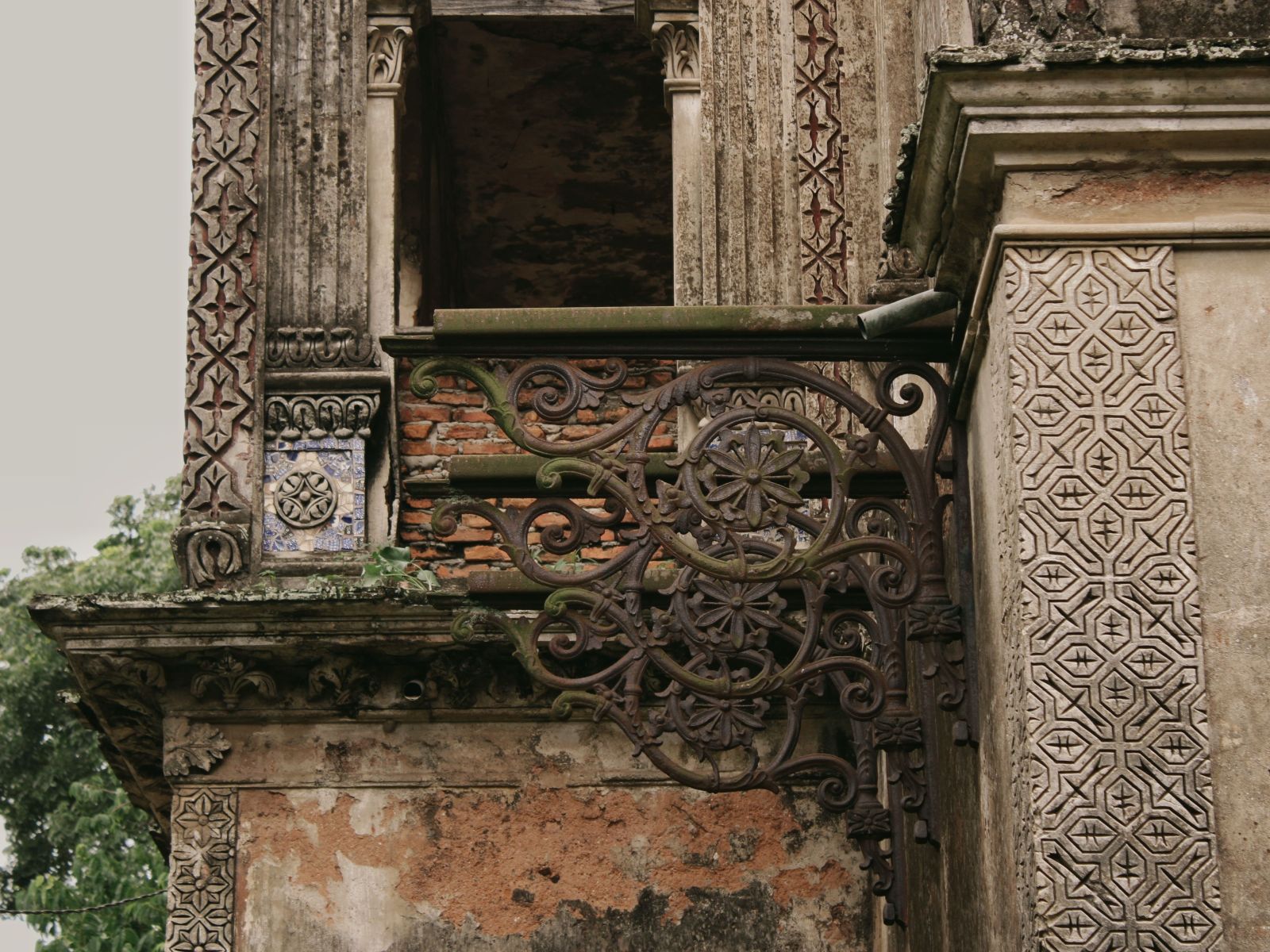 A close-up of ornate, antique architecture, showcasing intricate wrought-iron details and weathered stone textures.