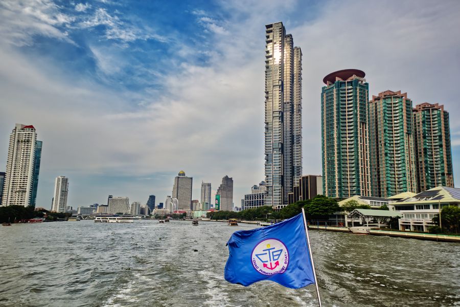 A stunning view of the Bangkok skyline from a ferry on the Chao Phraya River, Thailand.