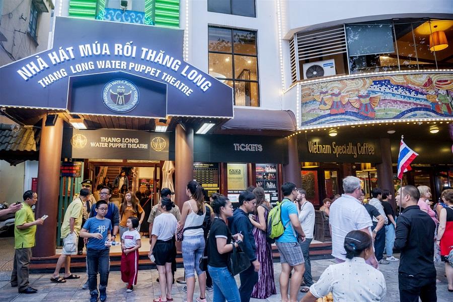 Tourists line up to check in