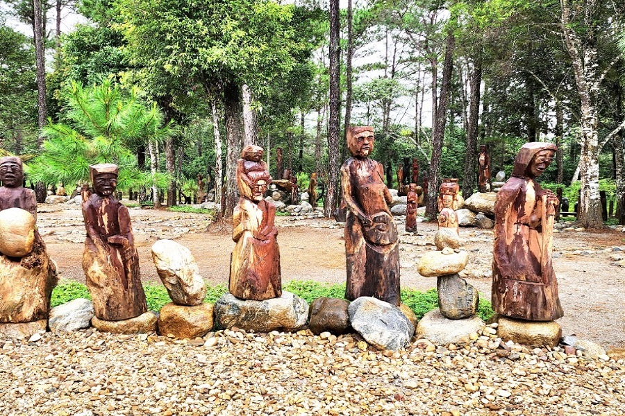 The wooden sculpture garden is a must-see at Pa Sy Waterfall