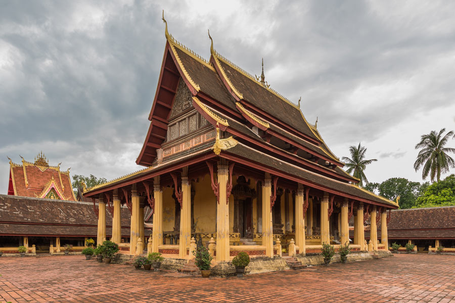 Explore the ancient Khmer ruins at Wat Phu in Champasak, a temple complex that predates the Angkor Wat in Cambodia