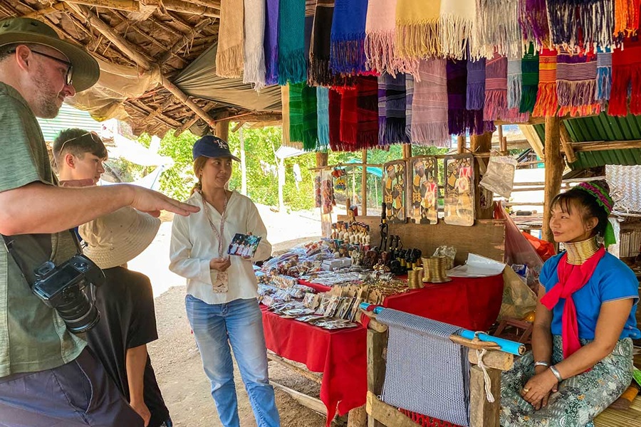 Travelers exploring Long Neck Karen culture