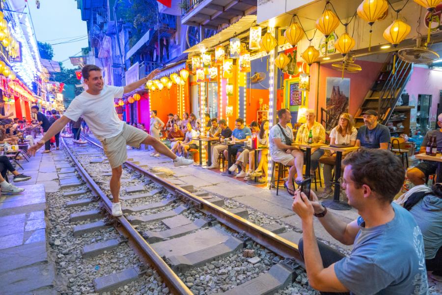 International tourists take photos at the Train Street Café in Hanoi 