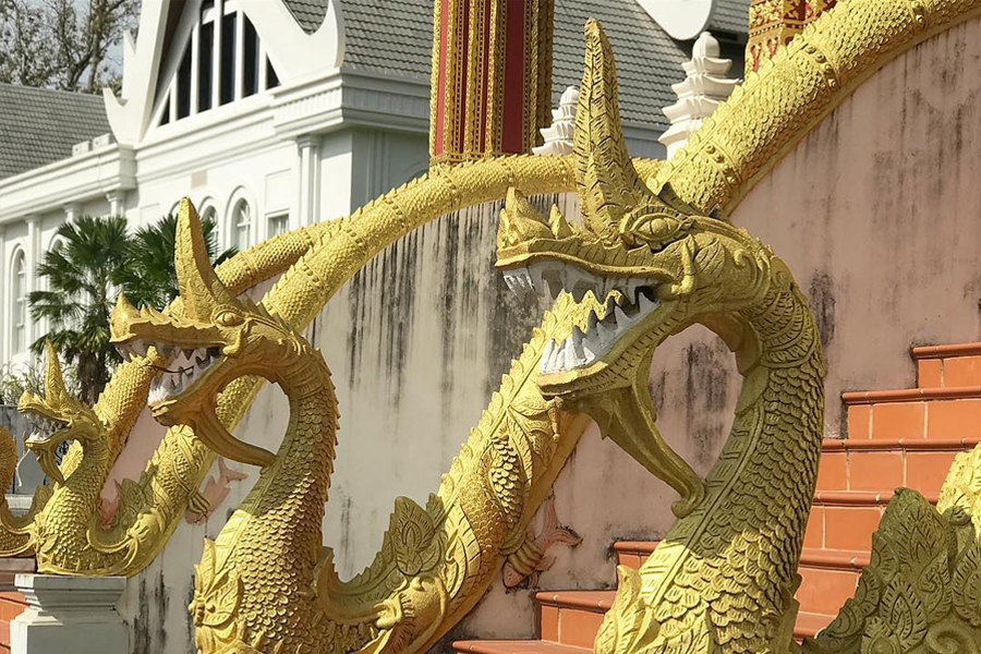 Stone dragons carved along the stairs to Haw Phra Kaew